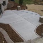 Concrete patio with brick border installed in Ozaukee County
